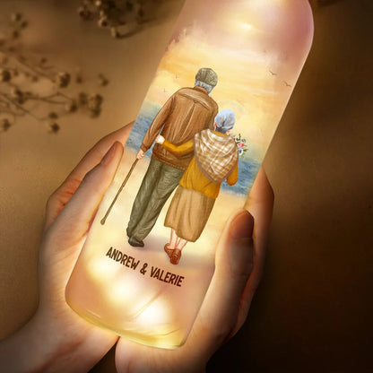 Personalized frosted glass bottle light with couple design, warm LED glow, 'Our Home Ain't No Castle' text